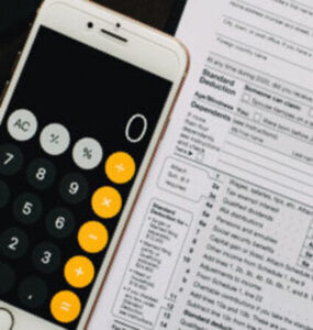 mac phone with calculator open next to tax forms (2)
